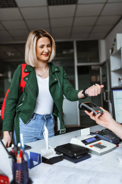 istock Blond Female Embracing Modern Technology While Paying For Delivery Service Via Smartwatch 2096676106