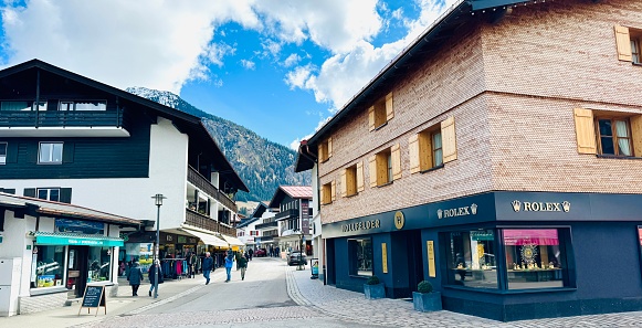 Oberstdorf, Germany - March, 11th - 2024: typical street and shops in downtown.