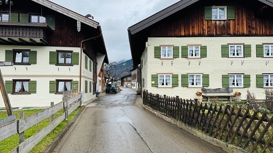 Oberstdorf, Germany - March, 12th - 2024: traditional wooden houses and street in downtown.