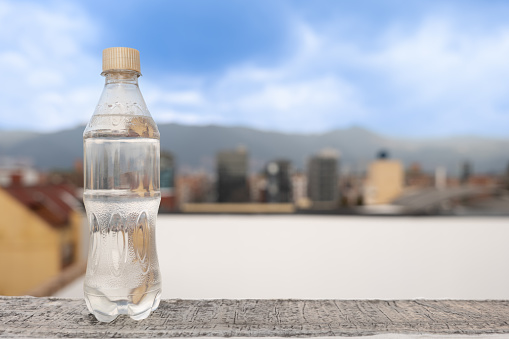 Plastic Bottle with a variety of fun and creative backgrounds, nature, city landscapes. Product is the focus.