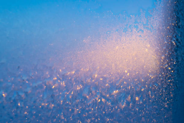 Frost on the glass. Beautiful frosty patterns. Winter background. Ice texture.