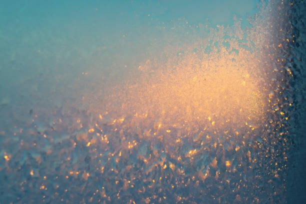 Frost on the glass. Beautiful frosty patterns. Winter background. Ice texture.