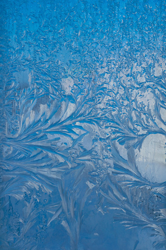 Ice surface with frozen air bubbles, close-up natural texture