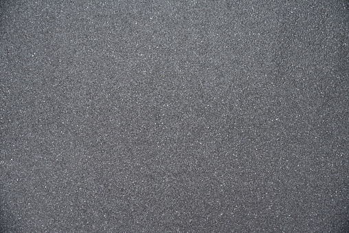 Texture of gray asphalt marble chips on flat roof