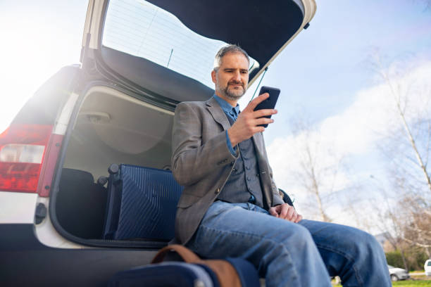 istock Man using mobile phone while he's on business travel 2096718602