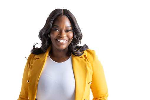 Happy, smiling black woman in a yellow blazer on white background