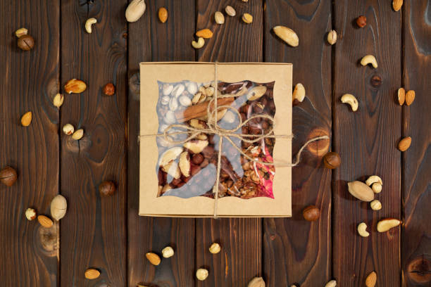 istock Nuts of different varieties in a box on a structural wooden background top view. 2096745012