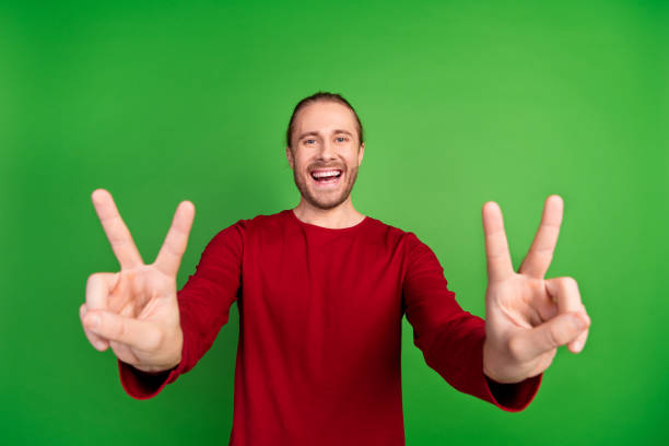 istock Photo of optimistic funky man with stubble long hairdo dressed red pullover two hands showing you okey isolated on green color background 2096763750