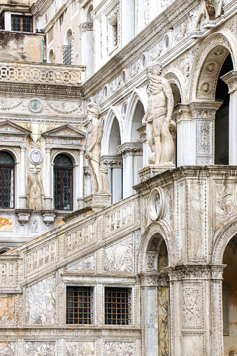 Vertical shot of the Giants' Staircase (Scala dei Giganti) of Doges Palace flanked by two statues of Mars and Neptune representing Venice's power by land and by sea - Venice, Italy