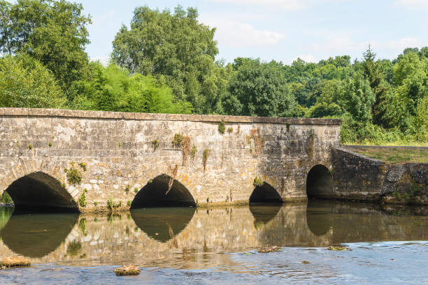 istock Old stones bridge with arches and river on summer sunny day 2096776640