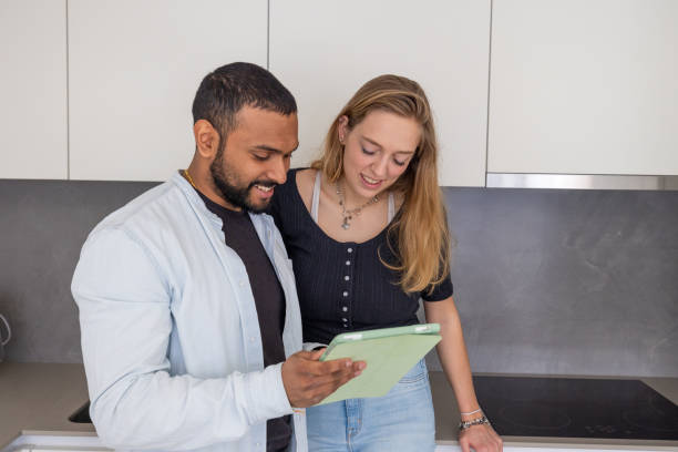istock Kitchen Connection: Couple Engaged with Digital Tablet in Their Home 2096784207