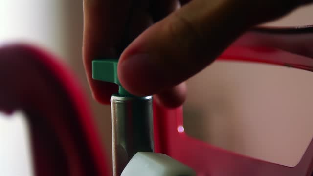 Man Moving the Valve of A Helium Tank for Balloons. Close Up. 4K Resolution.