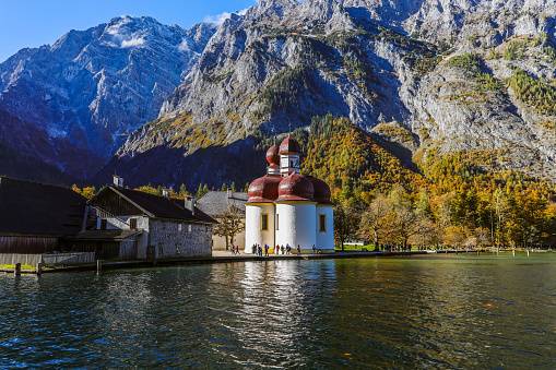 Bavaria, Germany- October 28, 2023: Konigsee lake with st Bartholomew church surrounded by mountains, Berchtesgaden National Park, Bavaria, Germany.