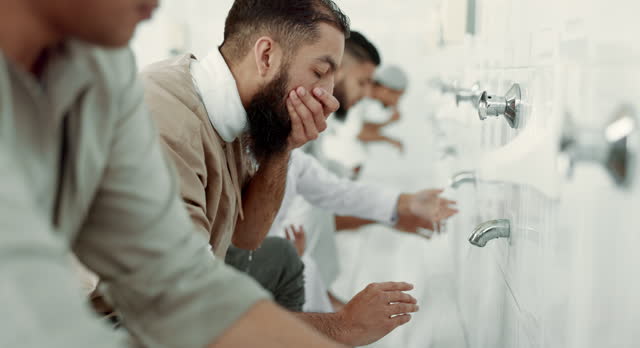 Muslim, religion ritual and men washing before prayer in bathroom for purity, and cleaning. Islamic, worship and faith of group of people with wudu together at a mosque or temple for holy practice