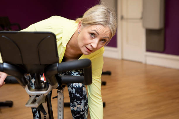 istock Woman getting ready to start cycling on an exercise bike 2096859228