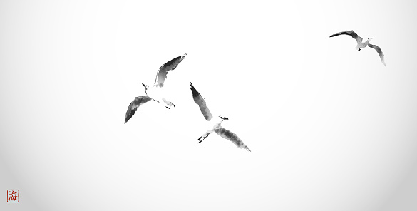 Minimalistic ink painting, displaying a trio of seagulls in flight. Traditional oriental ink painting sumi-e, u-sin, go-hua. Hieroglyph - sea.