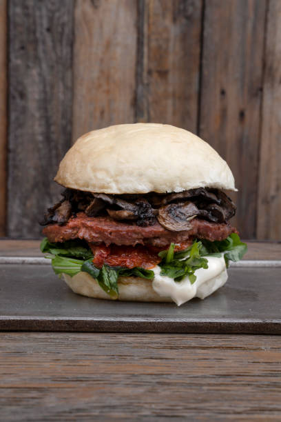 istock Closeup view of a plant based burger with a rustic wooden background 2096875499