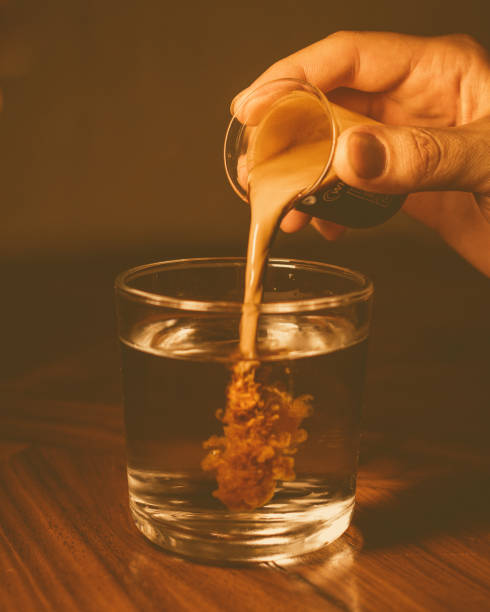 istock Person pouring espresso coffee into a glass jar on a table 2096879192