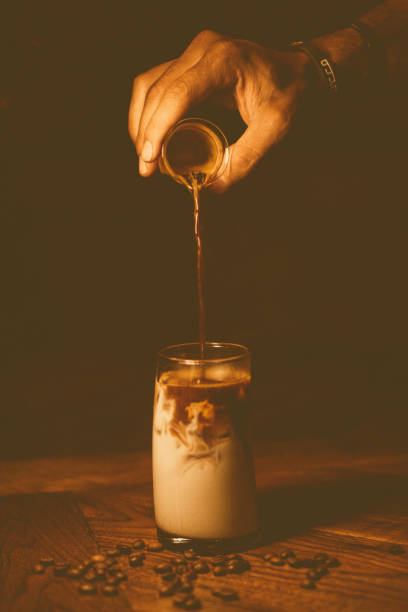 istock Hand pouring espresso coffee and ice cream into a glass 2096879210