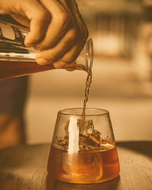 istock Man pouring espresso coffee from a pitcher into a glass 2096879218