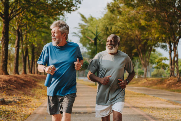 istock Two senior friends running in the public park 2096880832