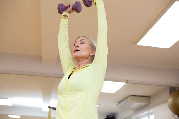 istock Woman weight training in a gym 2096881373