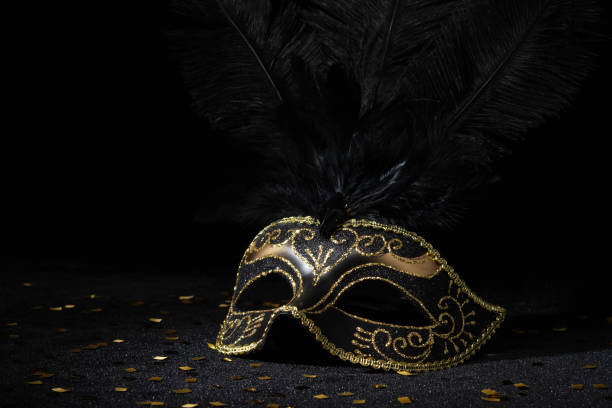 istock Masquerade gold mask with feathers and confetties on black background. 2096886740