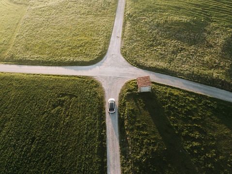 A car in a road intersection as seen from directly above