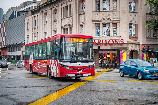 Kuala Lumpur, Malaysia - January 7th 2024:   City bus in traffic on a rainy day in a interception