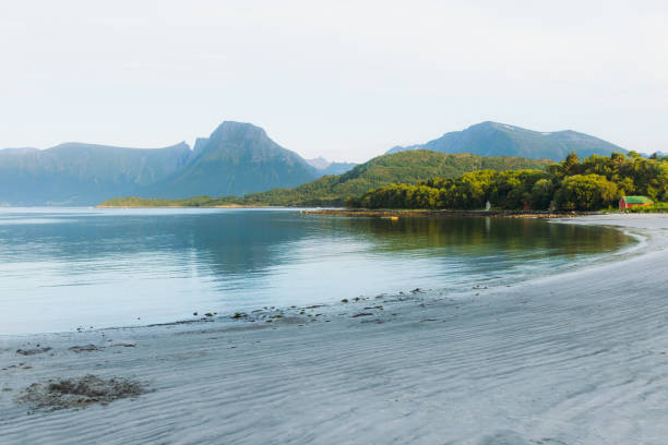 Dramatic view of summer landscape with beautiful seashore with background view of Sunnmore Alps in Western Norway, Scandinavia