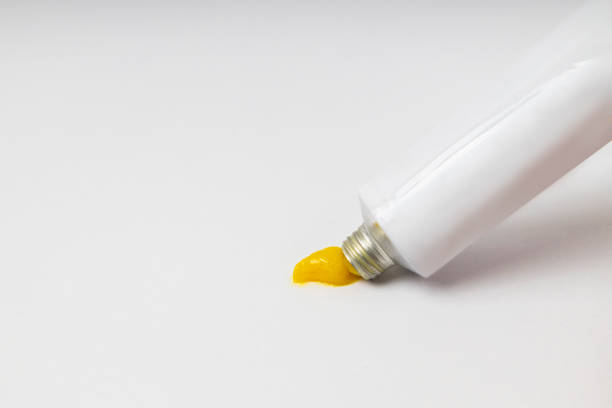 istock Opened ointment tube with yellow creme on the brigth background.Empty space 2096953516
