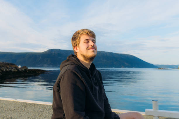 istock Happy Man Enjoying Summer Weekend by Scenic Seashore in Norway 2096954604