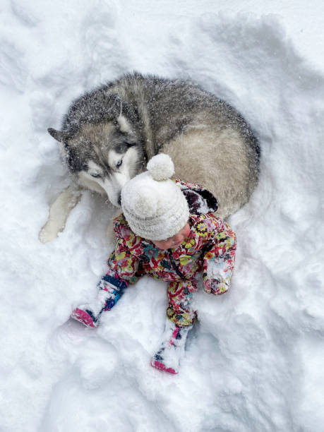 Baby with her dog in the deep California Snow