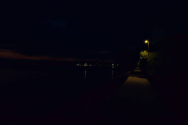 Bridge over a lake with lit street lights at dusk