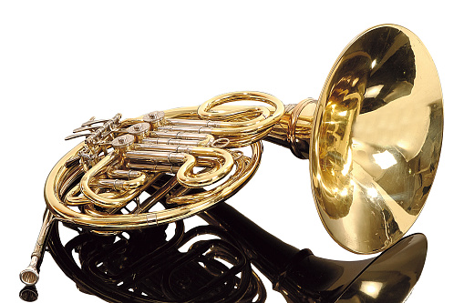 Gold colored trumpet as an isolated musical instrument against a white background in a studio