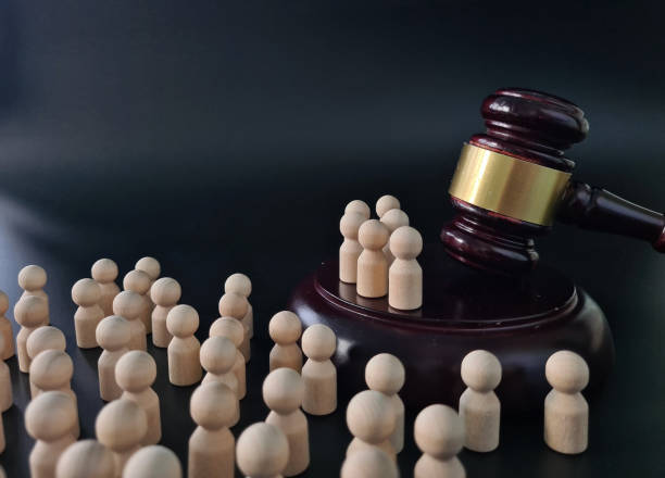 istock Judges Gavel Surrounded by Small Wooden People 2097031336