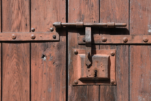 An old iron lock on the wooden door