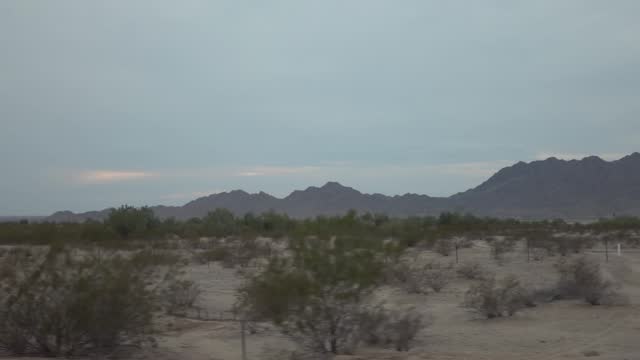 Desert highway with mountain backdrop in Arizona in slow motion 120fps