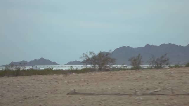 Desert highway with mountain backdrop in Arizona in slow motion 120fps