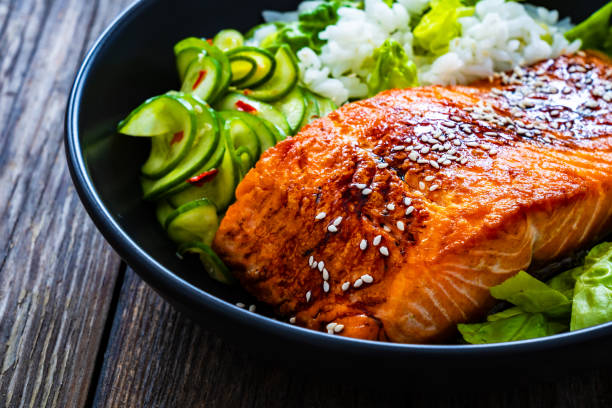istock Seared teriyaki salmon steak with white rice on wooden table 2097083323