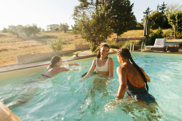istock Female friends enjoying a day at the pool 2097085480