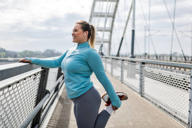 istock Woman Stretching Legs on Bridge 2097097635