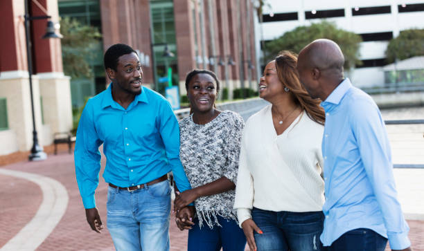 istock Two African-American couples walking in city 2097099734