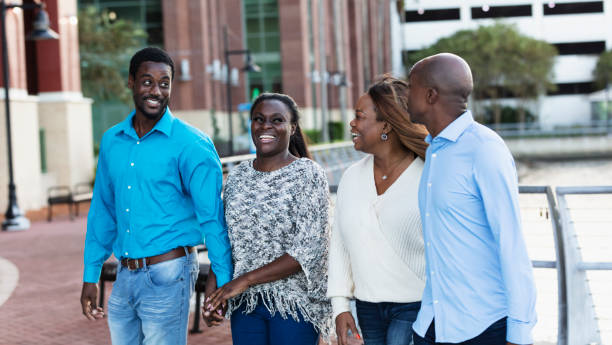 istock Two African-American couples walking in city 2097099736