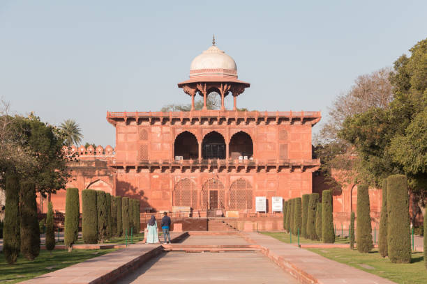 The origin of Taj Museum goes back to 1906 in two hexagonal rooms in the Western Jal Mahal which is now a part of the Taj Mahal complex. At that time, 1906, Taj Museum exhibits included old plans of Agra Fort and Taj Mahal, samples of the stone and tools used in inlay work, old photographs of the Taj Mahal, a few coloured drawings, Farmans (Royal orders), Sanads (land records), articles discovered during excavations in Agra Fort, specimens of precious stone used in the Taj and an album of old photographs of the Taj Mahal. Now displayed various exhibits relating mostly to the construction of Taj Mahal and to the Mughal period.\n\nTaj Mahal was built by Shah Jahan Imperaror, Taj is a memorial to is wife Mumtaz. A dream on white marble on the banks of sacred  Yamuna River. One of the most visited memorials of India and the world. It is a World Heritage Site by UNESCO since 1983 and one of the seven wonders of the modern world since 2007.