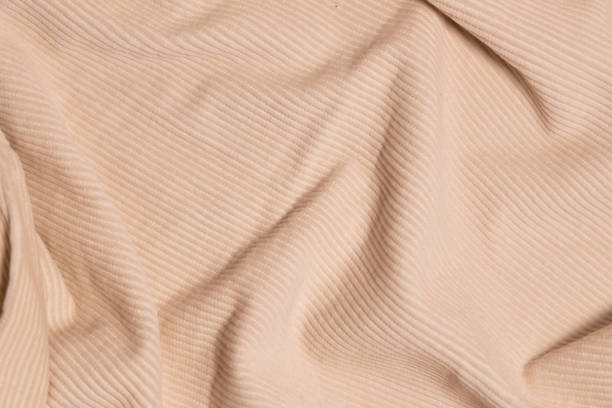 istock Velvety fabric texture pattern. Texture of velvet textile nude color. 2097107932