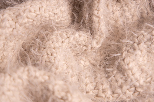 White knitwear texture. Soft texture of homemade cashmere wool sweater