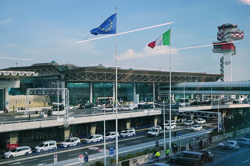 Rome, Italy - Feb 20, 2024:  The exterior and parking at the Fiumicino airport, Leonardo da VinciFiumicino Airport, Aeroporto di Roma, Fiumicino Leonardo da Vinci, and control tower.