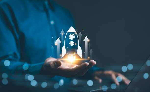 istock Business growth concept. Professional businessman projecting a holographic rocket symbolizing startup success and growth acceleration. Rising earnings, increasing financial profits, Wealth fast, 2097127391
