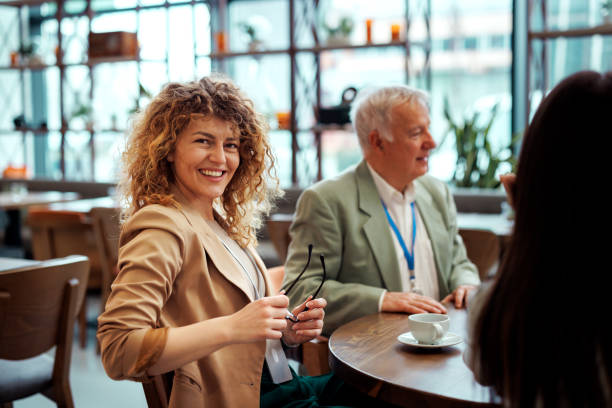 istock Beautiful well dressed businesswoman posing for a shot while having a coffee break with her colleagues at the restaurant 2097190376